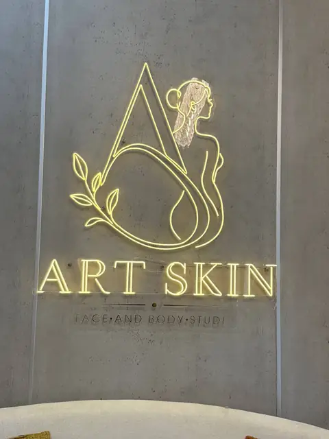 Art Skin: неоновая вывеска с логотипом в интерьере